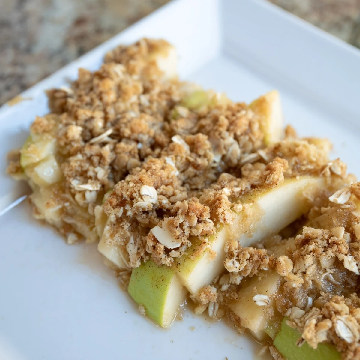 Golden-brown Rustic Apple and Cinnamon Crumb Bake, warm with bubbling apples and a sweet aroma.