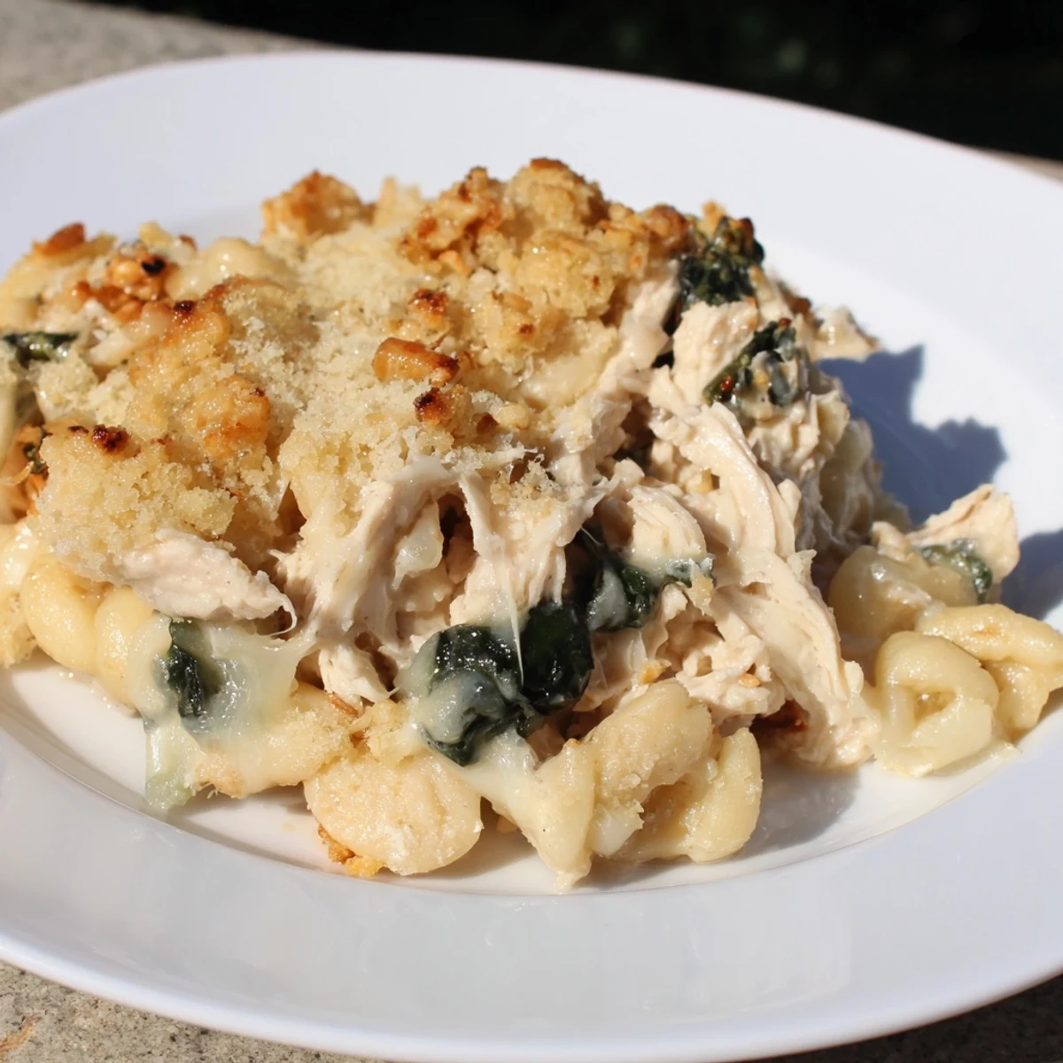 A close-up of creamy Marry Me Chicken Casserole, showcasing juicy chicken and sun-dried tomatoes' textures.