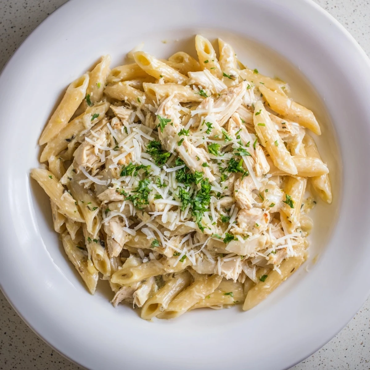 A close-up of Tini's Creamy Chicken Pasta, showcasing the rich cream sauce and tender chicken.
