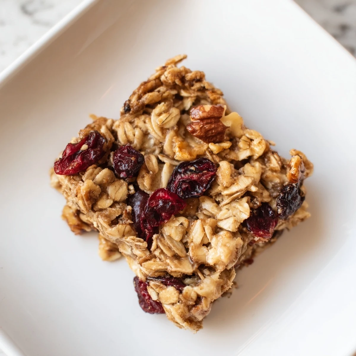 Golden-brown Maple Cinnamon Oatmeal Bars, freshly baked and bursting with warm, spiced flavors.