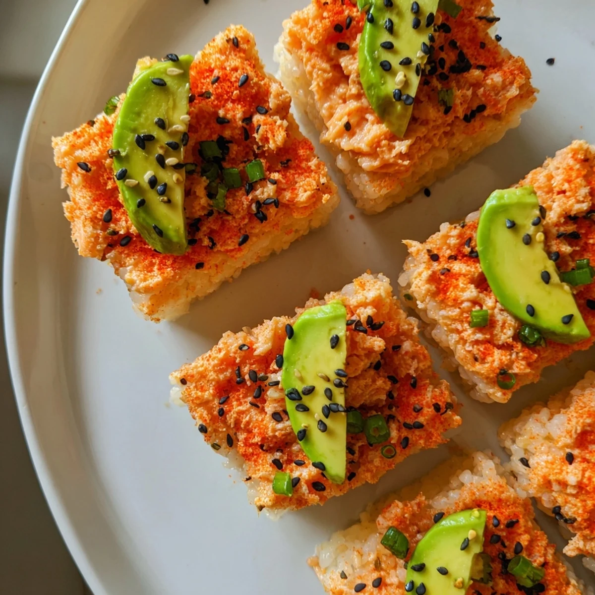 Golden-brown Spicy Tuna Crispy Rice appetizers are topped with creamy, vibrant tuna and avocado.