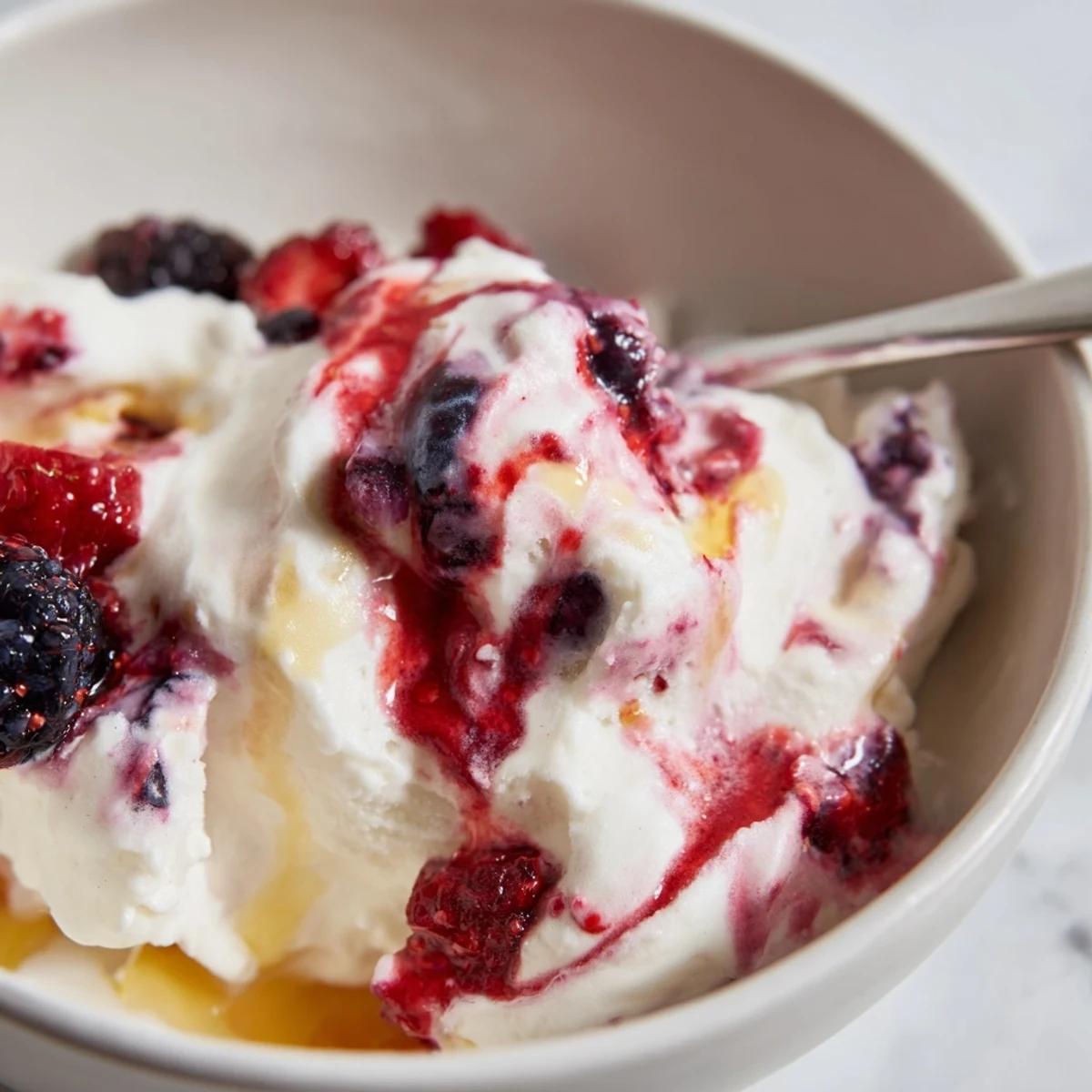 Creamy Cottage Cheese Ice Cream, swirled with berries, looks refreshingly cold and ready to enjoy.