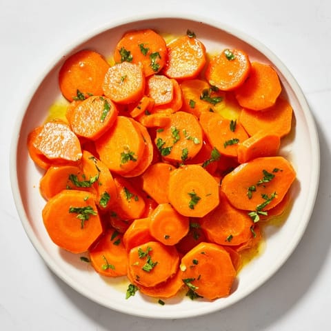 Shiny, golden honey-glazed carrots, a classic American side dish, ready to savor.