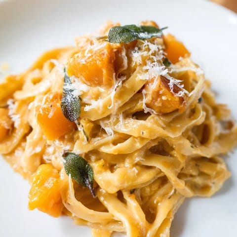 Fettuccine coated in golden butternut squash pasta sauce with aromatic sage and parmesan.