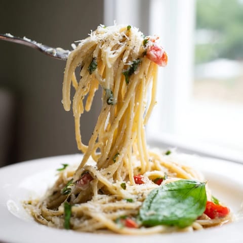 Steaming Roasted Garlic Pasta Sauce in a skillet, featuring caramelized onions and a creamy texture with fresh basil.
