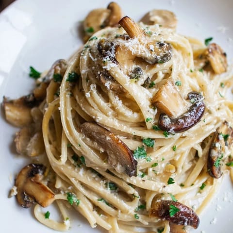 Freshly cooked Creamy Mushroom Linguine in a white bowl, featuring tender mushrooms and a light Parmesan cream sauce.  