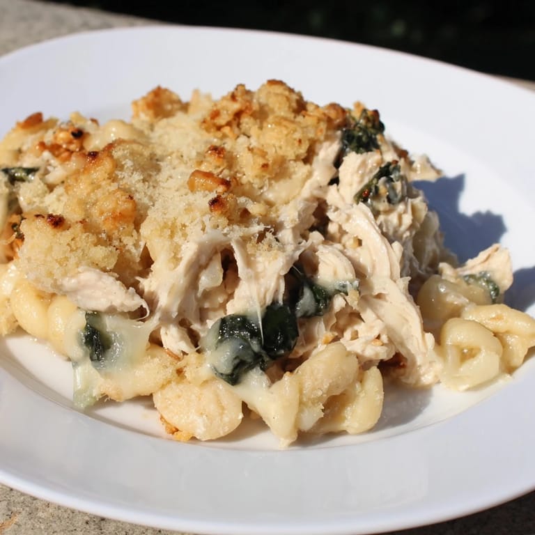 A close-up of creamy Marry Me Chicken Casserole, showcasing juicy chicken and sun-dried tomatoes' textures.