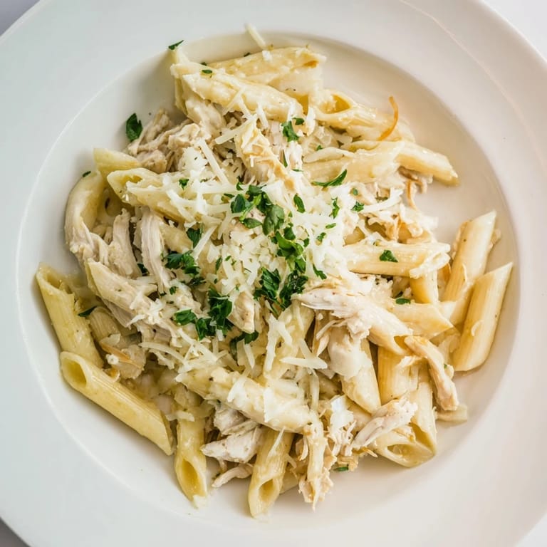 Savory Tini's Creamy Chicken Pasta, garnished with fresh parsley, perfect for a cozy weeknight dinner.