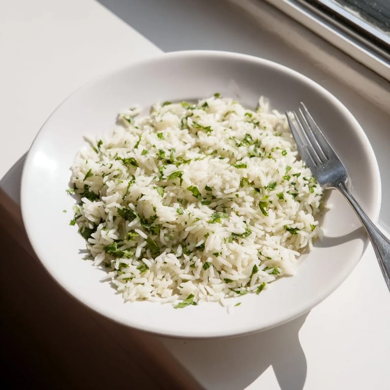 A vibrant bowl of fluffy Cilantro Lime Rice topped with cilantro and fresh lime zest, ready to serve.