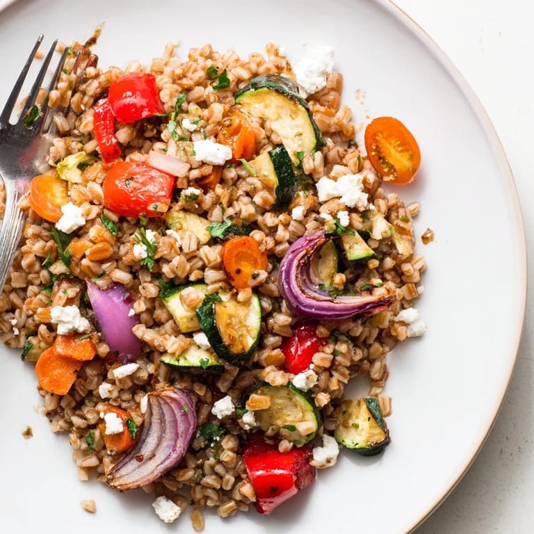 Golden roasted carrots and red onions enhance the Farro With Roasted Vegetables, topped with fresh parsley for a vibrant, healthy meal.