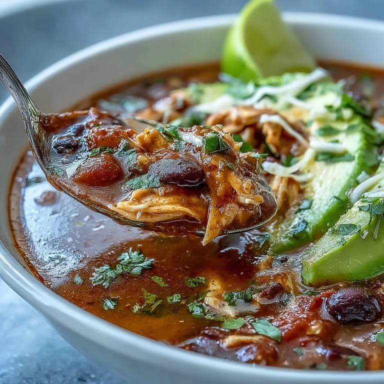 Hearty Instant Pot Chicken Tortilla Soup with tender shredded chicken, black beans, and fresh cilantro garnish.
